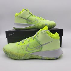 a pair of nike shoes in neon yellow and white on top of a black box