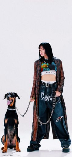 a woman standing next to a black and brown dog on a white background with her tongue out