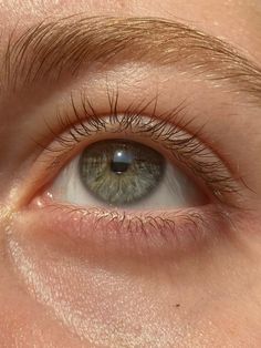 a close up view of an eye with long eyelashes