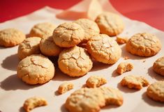 a bunch of cookies that are sitting on a paper towel next to some oranges