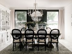 a dining room table with chairs and a chandelier