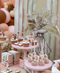 a table topped with lots of cupcakes and cakes