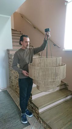 a man is holding a basket on the stairs