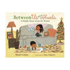 the children's book between us and abuella is shown in front of a couch