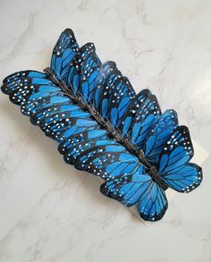 a group of blue butterflies sitting on top of a white counter