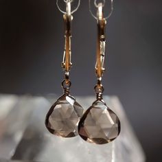 Beautiful natural smoky quartz earrings are handcrafted in 14k Gold and finished with leverback closure.  MATERIALS: * 14k Gold * natural Smoky Quartz * beautiful branded gift box + card about smoky quartz SIZE: stones: 8x8 mm; earrings: 2.5 cm or 1" MAKE A SET: Matching necklace: https://etsy.me/2DiWED2 SMOKY QUARTZ: * balances all Chakras In addition to the generic healing properties of Quartz, Smokey Quartz is an excellent grounding stone. It gently neutralizes negative vibrations and is deto Smokey Quartz Earrings, Expensive Jewellery, Smoky Quartz Jewelry, Smoky Quartz Earrings, Smokey Topaz, Les Chakras, Quartz Jewelry, Faith Prayer, Expensive Jewelry