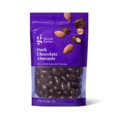 dark chocolate almonds in a bag on a white background