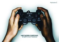 two hands holding a video game controller over a white background with the words, sony network gaming start in focus