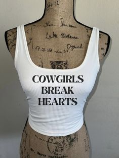 "\"Cowgirls Break Hearts\"  tank top! Comes in white, tan/beige, or dusty blue! Perfect for summer time, bathing suit cover up! Any occasion! Breathable material. Western wear, country concert, wash on cold and delicate setting for longevity! Visit my page for similar styles!  Feel free to message me with any questions and I'm sure we can work something out! Ex. Can you do the letters in red instead?" Heart Tank Top, Beige Shirt, Bid Day Themes, Bathing Suit Cover Up, Country Concerts, Summer Crop Tops, White Summer, White Tank Top, Western Wear