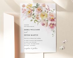 a wedding card with watercolor flowers on it