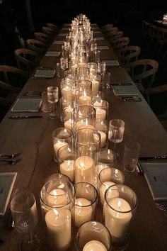 a long table with many lit candles on it