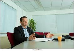 a man sitting at a table in an office