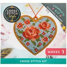 the cross stitch kit includes a heart shaped ornament with flowers and leaves on it