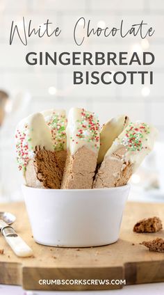 a bowl filled with cookies and sprinkles on top of a wooden cutting board