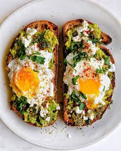 two pieces of bread with eggs on top and broccoli sprouts in the middle