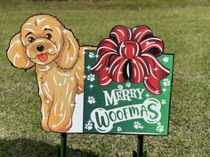 a merry wooofmas sign with a dog's bow on it in the grass