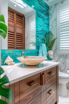 a bathroom with blue tile and wooden cabinets