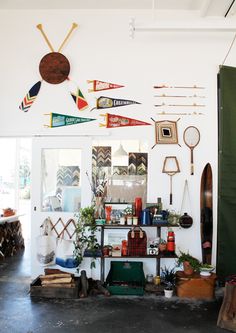 a room filled with lots of assorted items and decor on the wall next to a green door