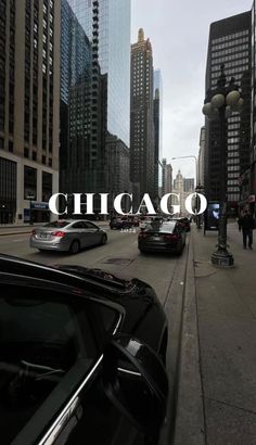 the chicago sign is in front of some tall buildings and cars driving down the street