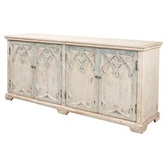 the sideboard is white and has ornate carvings on it, along with measurements for each section