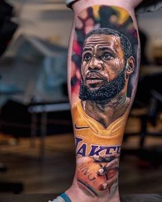 a man's leg with a tattoo of a basketball player and his name on it