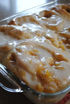 a glass casserole dish filled with food on top of a table