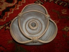 a white bowl sitting on top of a red rug