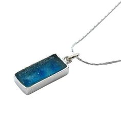 Delicate Rectangle Roman Glass Pendant * 18" Silver Chain Included With Pendant Delicate Rectangle design in sterling silver Ancient Roman glass pendant. This beautiful pendant is set with a long rectangle piece of ancient Roman glass multicolor of aqua, blue and greens. The setting is sterling silver with an organic, modern design. This is a stunning, one of a kind artisan piece. Product Details Pendant Size: 0.9/0.4 inch or 2.2 / 1 cm Metal: .925 Sterling Silver Origin: Artisan Handmade In Isr Organic Modern Design, Roman Glass Jewelry, Rectangle Design, Ancient Roman Glass, Nickel Free Jewelry, Roman Glass, Silver Jewellery Sets, Delicate Jewelry, Romantic Gift