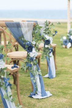 blue and white wedding decorations on wooden chairs