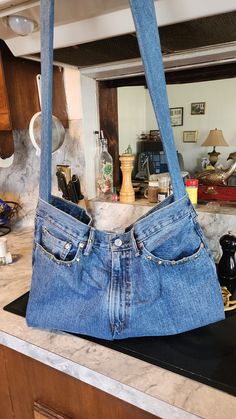 an old pair of jeans hanging from a kitchen counter