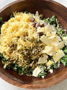 a wooden bowl filled with different types of food