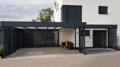 a black and white house with an attached carport