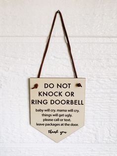 a sign hanging on the wall that says do not knock or ring doorbell