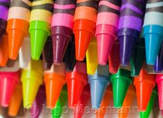 many different colored crayons are lined up together