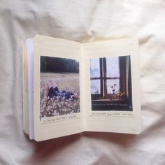 an open book with pictures of people laying on the ground in front of a window