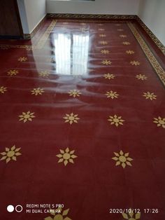 a red and gold tiled floor in an empty room