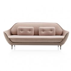 a pink couch sitting on top of a white floor