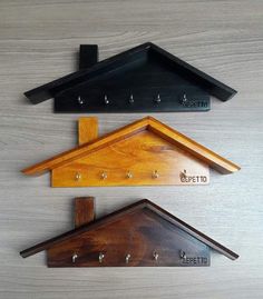 three wooden shelfs with metal hooks on each one and a sign that says specto