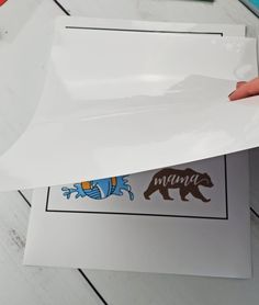 someone is holding up some stickers to show off their bear decal designs on paper