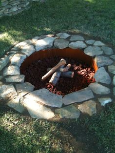 an outdoor fire pit made out of stones