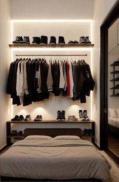 a bedroom with clothes and shoes hanging on the wall, along with a large bed