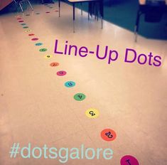 the line up dots are on the floor in front of a table with chairs and desks