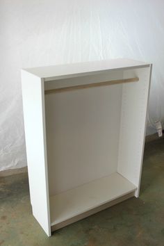 a white shelf sitting on top of a floor