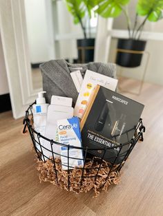 a basket filled with personal care items sitting on top of a wooden table next to a potted plant