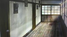 an empty room with wooden floors and windows on the wall, in front of a door