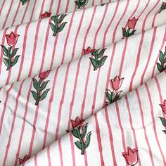 a red and white striped fabric with pink flowers on the front, and green leaves on the back