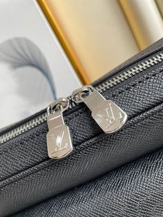 For Spring-Summer 2019, Louis Vuitton brings together Taiga leather with Monogram canvas in a faux monoblock that complements the bold design of the Outdoor Messenger bag. The tone-on-tone colorway is accented with silver-color hardware, including a zipper across the front. The adjustable shoulder strap means it’s easy to wear. Detailed Features 26 x 20 x 10.5 cm (Length x height x width ) Black Taiga cowhide leather and Monogram Eclipse coated canvas Cowhide-leather trim Textile lining Silver-c High-end Silver Travel Bag, Modern Silver Bag For Business, Designer Business Bags With Silver-tone Hardware, Designer Travel Bag With Silver-tone Hardware, Vuitton Bag, Sierra Leone, Monogram Canvas, Cowhide Leather, Bottega Veneta