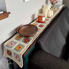 a table with some candles on top of it and a plate next to the edge