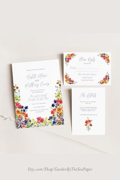 the wedding stationery is decorated with colorful flowers