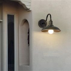 an outdoor light on the side of a house with numbers and address cards attached to it